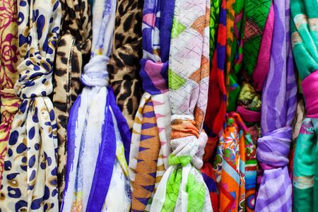 Close up of women's scarves hanging in a store
