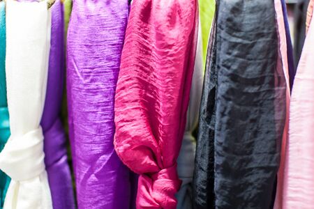 Close up of women's scarves hanging in a store