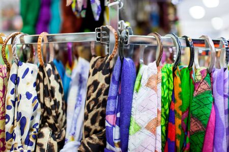 Close up of women's scarves hanging in a storeの写真素材