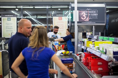 CYPRUS, PROTARAS, SUPERMARKET LIDL - 12.10.2016: Customers paying for shopping at a supermarket. Line at the cashdesks in the supermarketのeditorial素材