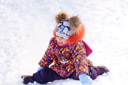 Girl having fun in a winter parkの写真素材