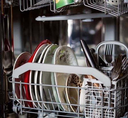 Open dishwasher with clean disheの写真素材