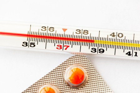 Thermometer with high temperature and orange pills
