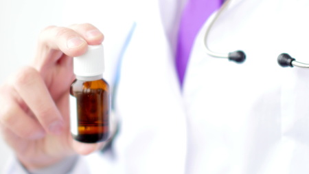 Medical doctor holding a prescription pill bottle.の写真素材