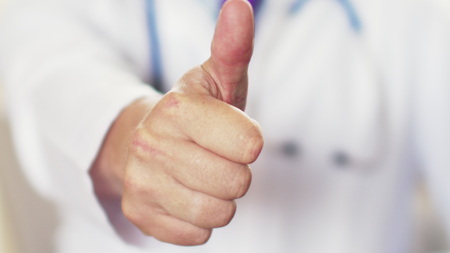 close up of male doctor hand showing thumbs up.の写真素材