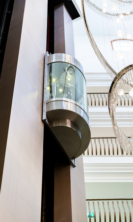 Glass elevator in the modern building