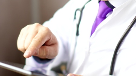 Medical doctor using touchscreen digital tabletの写真素材