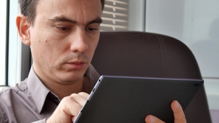 Businessman in shirt using modern digital tablet