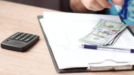 Male hands counting dollars banknotesの写真素材