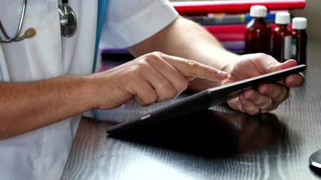 Doctor using digital tablet at the hospitalの写真素材