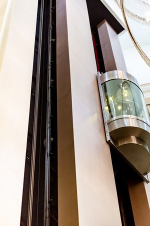 glass capsule elevator in the hall at luxury hotelの写真素材