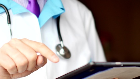 Medical doctor using modern touchscreen digital tabletの写真素材