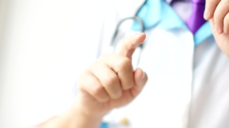 Male doctor gesturing and explaining something for patient.の写真素材