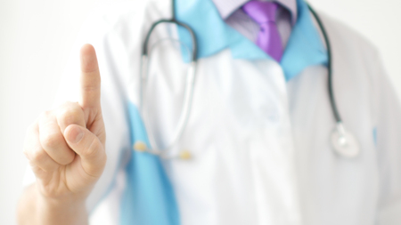 Medical doctor using one finger for pressing virtual touch screenの写真素材