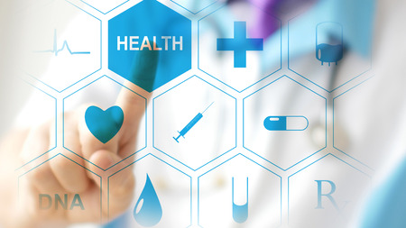 Doctor pressing virtual button on touchscreen. Concept of modern healthcareの写真素材