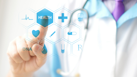 Doctor pressing virtual button on touchscreen. Concept of modern healthcareの写真素材