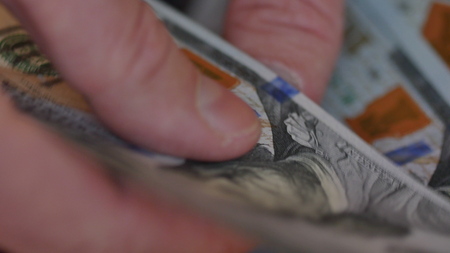 View of a man counting many american 100 billsの写真素材