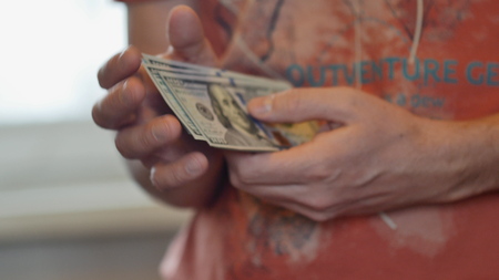 View of a man counting many american 100 billsの写真素材