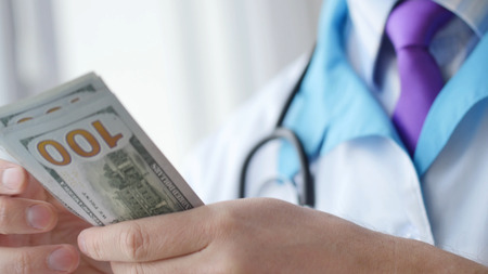 Corrupted medical doctor counting money.