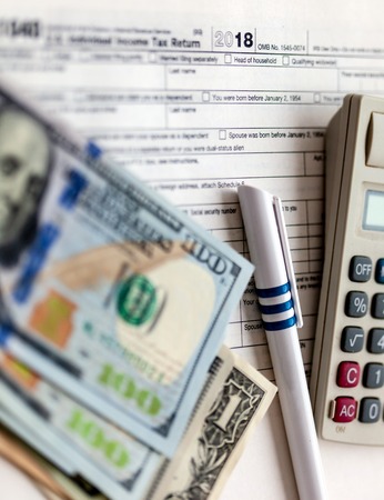 US tax form 1040 with pen and calculator.
