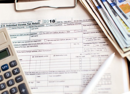 US tax form 1040 with pen and calculator.の写真素材