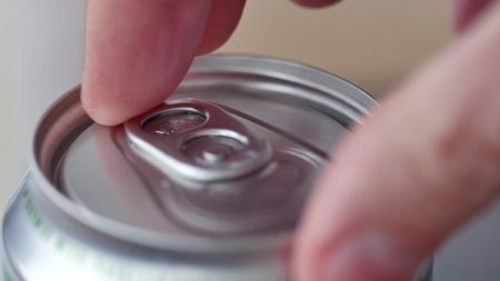 Male opening unmarked soda or beer can
