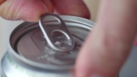 Male opening unmarked soda or beer can