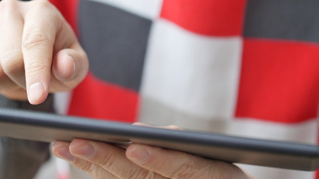 Man hand touching screen on modern digital tablet pc. Close-up image with shallow depth of field....