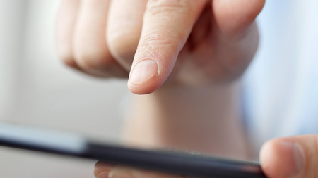 Man hand touching screen on modern digital tablet pc. Close-up image with shallow depth of field. Concept of modern gadgets in useの写真素材