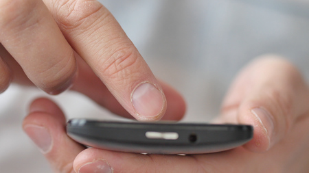 A man using apps on a mobile touchscreen smartphone. Concept of modern technology, shopping online and smart phonesの写真素材