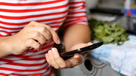 Close-up of young woman hands typing sms