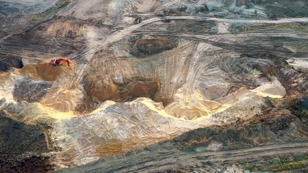 Aerial view of excavator loader inside of sand career.