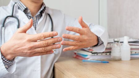The doctor explaining something for patient by making hands gestures.の写真素材