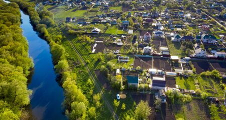 Drone view on garden allotments. Aerial drone photo of garden allotments near small river and forest