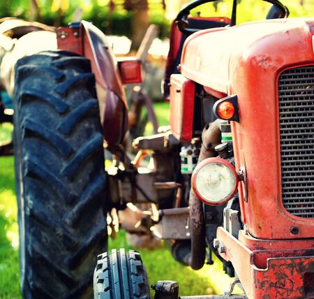 An old tractor in a field on a sunny day.の写真素材