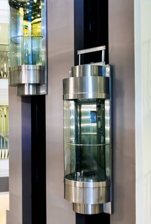 Two moving modern elevators in shopping centre.の写真素材
