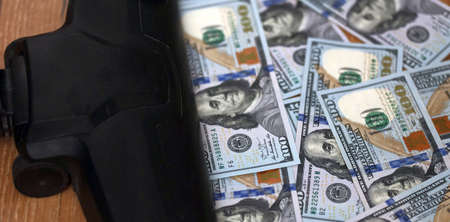 Vacuum cleaner head with one hundred dollars bill on a floor.の写真素材