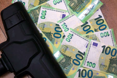 Vacuum cleaner and euro banknotes on a floorの写真素材