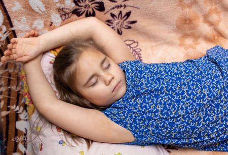 Child girl sleeping in a casual clothes on sofaの写真素材