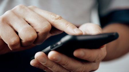 Close up of man hands are texting message on mobile smart phone