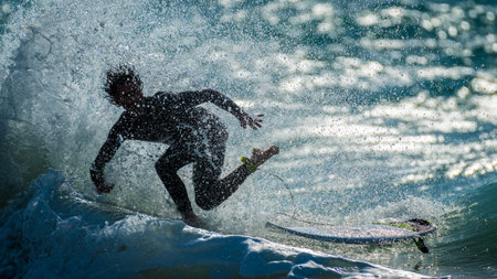 Isolated single surfer surfing the high waves in the sunset- Israel