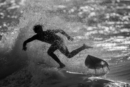 Isolated single surfer surfing the high waves in the sunset- Israelの写真素材