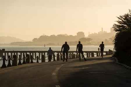 SAN FRANCISCO, USA - OCTOBER 12, 2018: People skating and running near Torpedo Wharf and Fort Point San Franciscoのeditorial素材