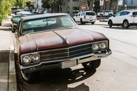 SAN FRANCISCO, CALIFORNIA, USA - OCTOBER 12, 2018: Detail of the front of a classic car on a street...