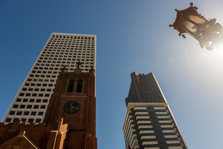 SAN FRANCISCO, CALIFORNIA, USA - OCTOBER 12, 2018:  Main tower of the old St. Mary's cathedral next to the modern and tall buildings of the financial district in San Francisco, California, USAのeditorial素材