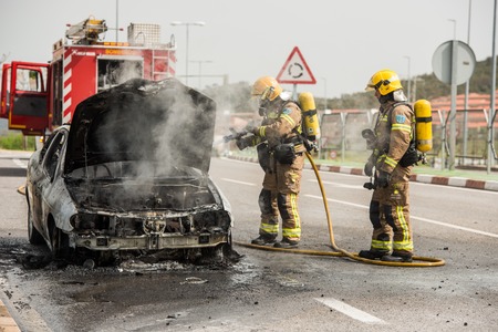 CACERES, EXTREMADURA, SPAIN - APRIL  24, 2018: Firefighters put out a car that has burned on a street in Caceres.のeditorial素材