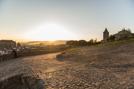 An older man contemplates the sunset over the village in Medellin, Extremadura, Spain.のeditorial素材