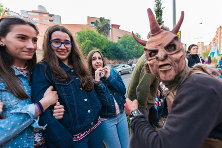People masquerading as demons frightening people on the occasion of the feast of St. George.