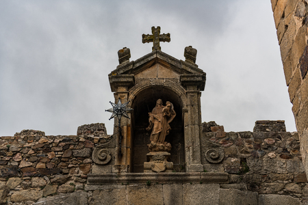Detail of the Nuestra Senora de la Estrella little temple at the top of the entrance arch to the old quarter of Caceres.の写真素材
