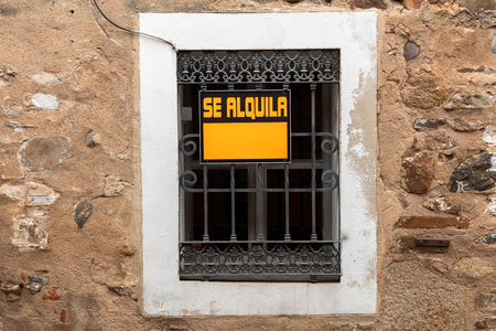 A window with a For Rent sign in the old town of Caceres.の写真素材